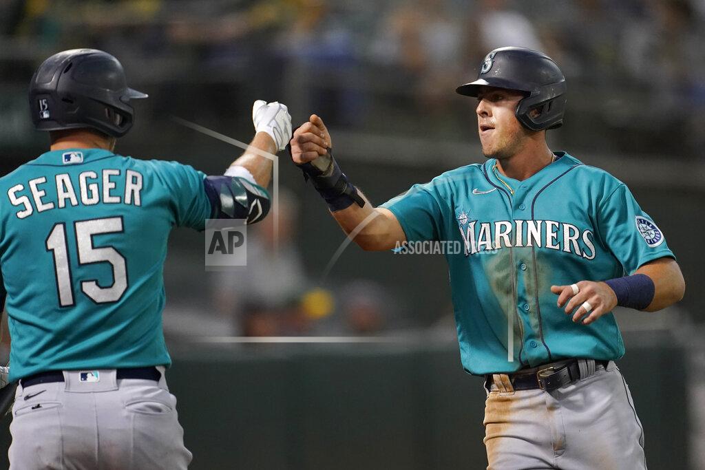 Jeff Chiu Seattle Mariners' Dylan Moore, right, is congratulated by Kyle Seager after scoring a run against the Oakland Athletics during the third inning of a baseball game in Oakland, Calif., Monday, Sept. 20, 2021. (AP Photo/Jeff Chiu)