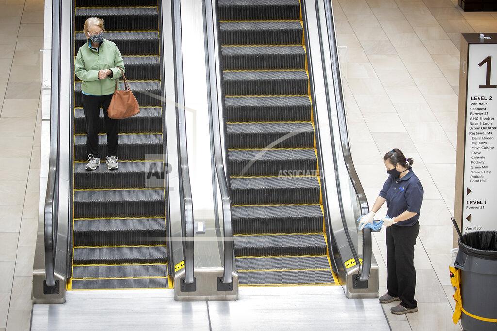 Elizabeth Flores Shoppers made their way through Rosedale Center as some of the stores opened for business during the coronavirus pandemic, Monday, May 18, 2020 in Roseville, Minn. (Elizabeth Flores/Star Tribune via AP)