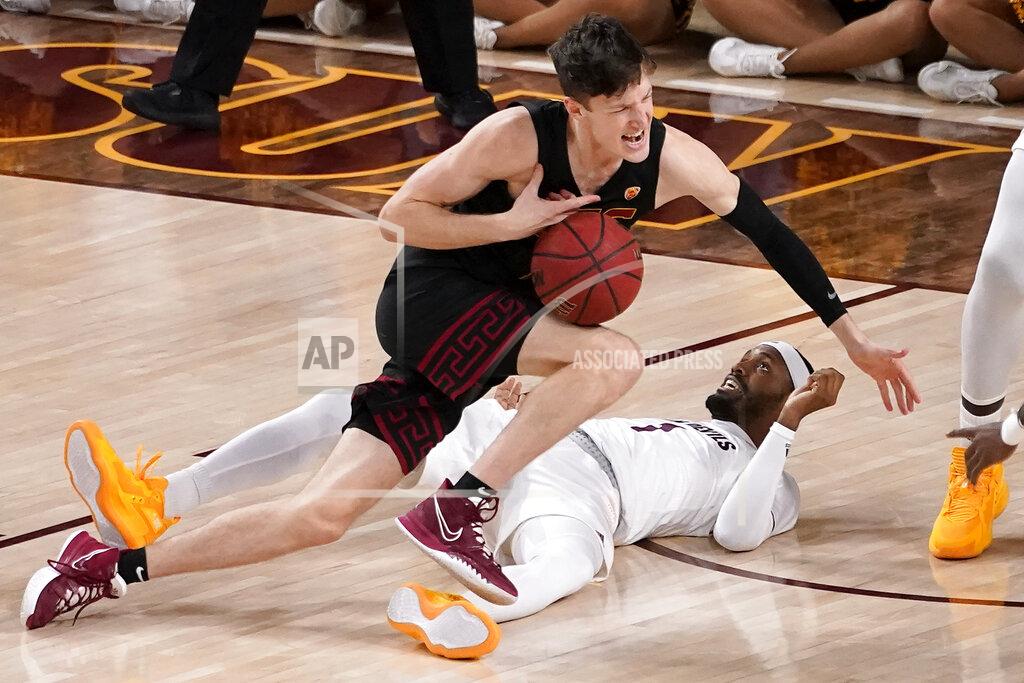 Matt York CORRECTS LOCATION TO TEMPE, INSTEAD OF PHOENIX - Southern California guard Drew Peterson fouls Arizona State guard Luther Muhammad, right, during the second half of an NCAA college basketball game, Thursday, Feb. 3, 2022, in Tempe, Ariz. (AP Photo/Matt York)