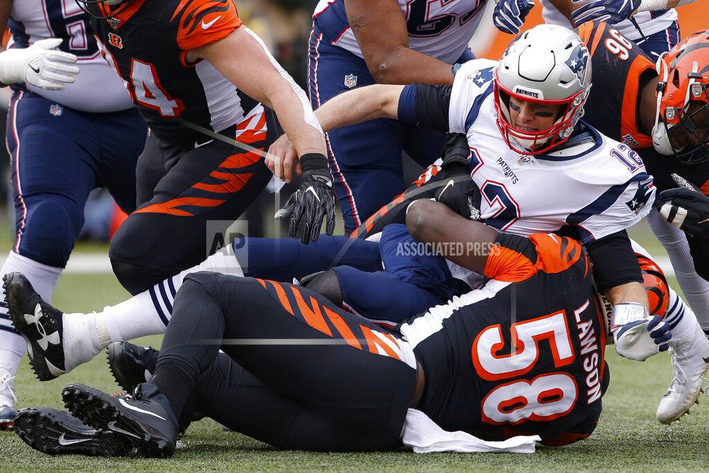 Gary Landers New England Patriots quarterback Tom Brady (12) is tackled after the pass by Cincinnati Bengals defensive end Carl Lawson (58) in the first half of an NFL football game, Sunday, Dec. 15, 2019, in Cincinnati. (AP Photo/Gary Landers)