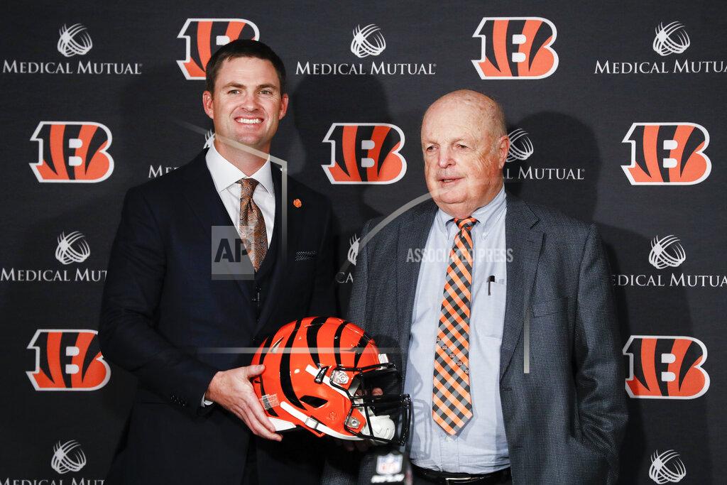 John Minchillo Cincinnati Bengals football head coach Zac Taylor, left, and Bengals owner Mike Brown, right, pose for a photograph during a news conference, Tuesday, Feb. 5, 2019, in Cincinnati. After 16 years without a playoff win under Marvin Lewis, the Bengals decided to try something different. But they had to wait more than a month before hiring Zac Taylor as their next coach in hopes of ending a long streak of futility. (AP Photo/John Minchillo)