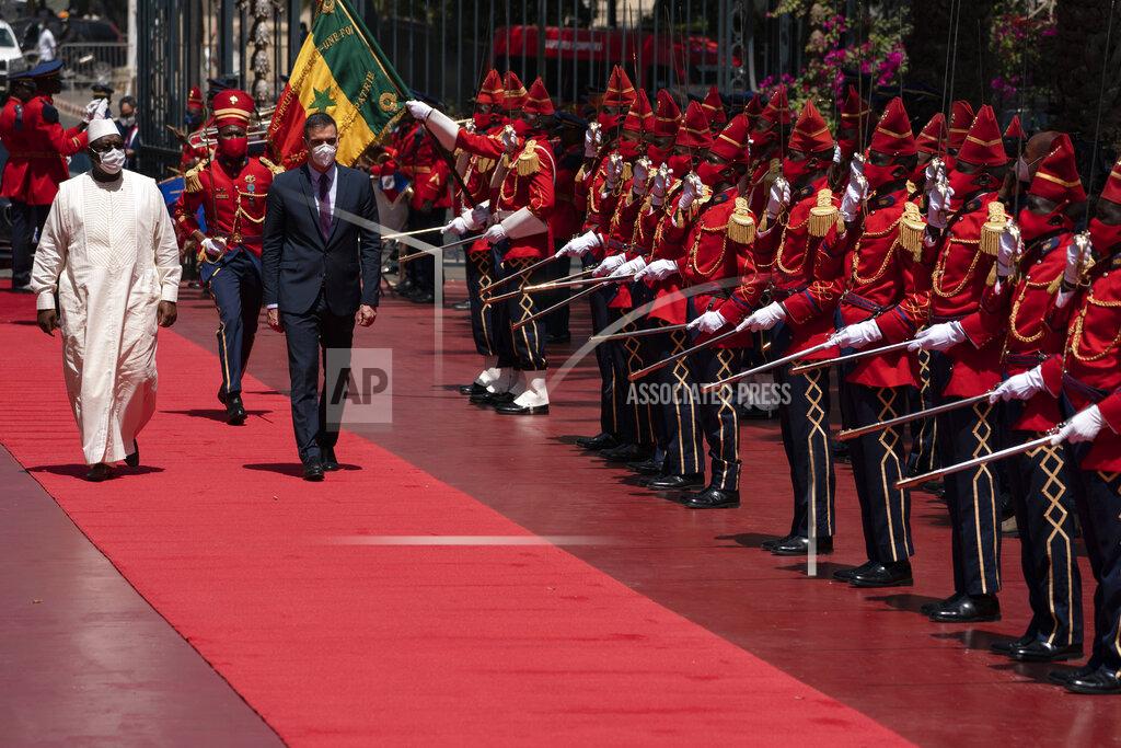 Leo Correa Senegal's President Macky Sall, left, and Spanish Prime Minister Pedro Sanchez review the troop during a welcoming ceremony at the presidential palace in Dakar, Senegal, Friday, April 9, 2021. Sanchez is on a mini-tour to Angola and Senegal that are key in the European country's new push to bolster ties with the neighboring continent and mitigate the migration flows that many fear could increase as a consequence of the coronavirus pandemic. (AP Photo/Leo Correa)
