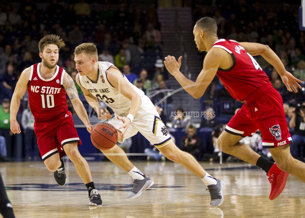 Robert Franklin Notre Dame's Dane Goodwin, center, drives between North Carolina State's Braxton Beverly (10) and Jericole Hellems (4) during the first half of an NCAA college basketball game Saturday, Jan. 19, 2019, in South Bend, Ind. (AP Photo/Robert Franklin)