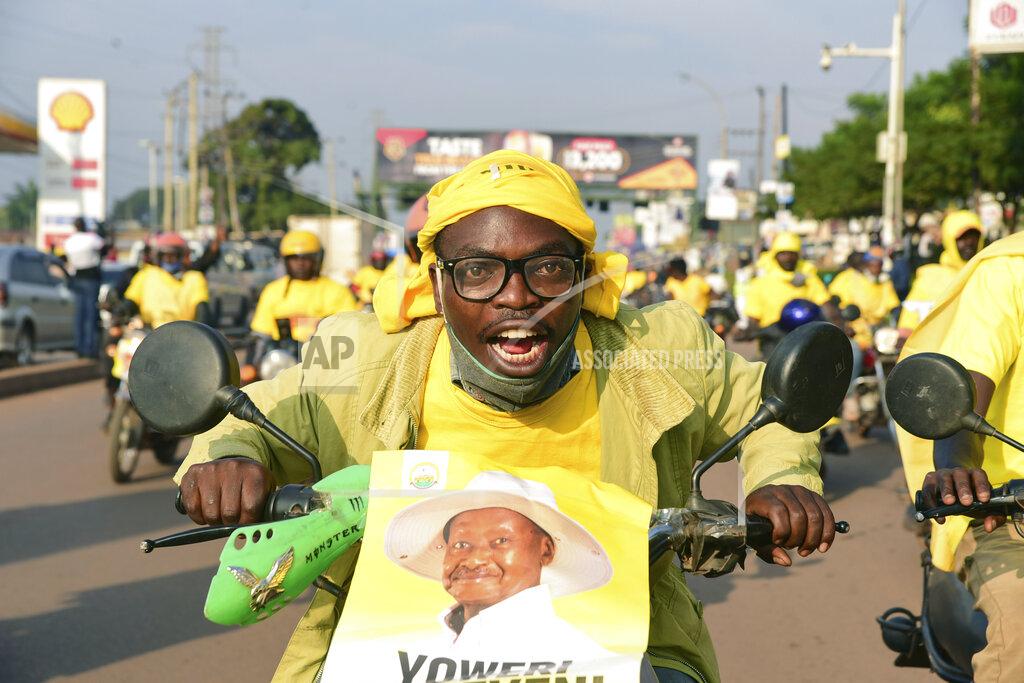 Nicholas Bamulanzeki A supporter of Ugandan President Yoweri Kaguta Museveni celebrates in Kampala, Uganda, Saturday Jan. 16, 2021, after their candidate was declared winner of the presidential elections. Uganda’s electoral commission says longtime President Yoweri Museveni has won a sixth term, while top opposition challenger Bobi Wine alleges rigging and officials struggle to explain how polling results were compiled amid an internet blackout. In a generational clash widely watched across the African continent, the young singer-turned-lawmaker Wine posed arguably the greatest challenge yet to Museveni. (AP Photo/Nicholas Bamulanzeki)