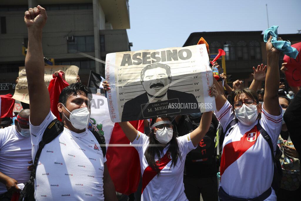 Rodrigo Abd Protesters asking that interim President Manuel Merino step down, hold a sign reading in Spanish "Murderer" shortly before Merino announced his resignation in Lima, Peru, Sunday, Nov. 15, 2020. Merino stepped down following massive protests unleashed when Congress ousted President Martin Vizcarra. (AP Photo/Rodrigo Abd)