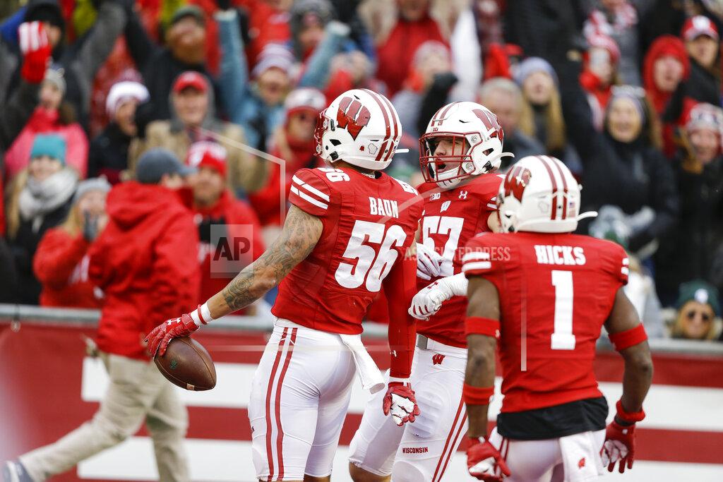 Andy Manis Wisconsin linebacker Zack Baun (56) celebrates an interception with teammates linebacker Jack Sanborn (57) and cornerback Faion Hicks (1) during the second half of an NCAA college football game against Michigan State Saturday, Oct. 12, 2019, in Madison, Wis. Baun scored a touchdown on the interception. Wisconsin won 38-0. (AP Photo/Andy Manis)