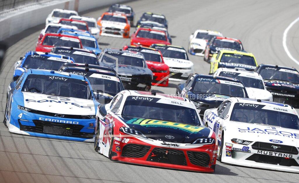 Carlos Osorio Christopher Bell, center, leads through the first turn during the NASCAR Xfinity Series auto race at Michigan International Speedway, Saturday, June 8, 2019, in Brooklyn, Mich. (AP Photo/Carlos Osorio)