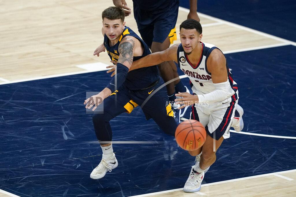 Darron Cummings West Virginia's Jordan McCabe (5) and Gonzaga's Jalen Suggs (1) eye a loose during the first half of an NCAA college basketball game Wednesday, Dec. 2, 2020, in Indianapolis. (AP Photo/Darron Cummings)