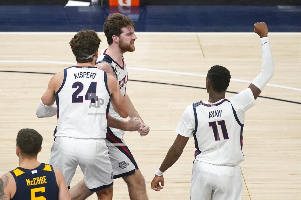 Darron Cummings Gonzaga's Drew Timme (2) celebrates with Corey Kispert (24) and Joel Ayayi (11) after Timme made a shot and was fouled during the second half of the team's NCAA college basketball game against West Virginia, Wednesday, Dec. 2, 2020, in Indianapolis. (AP Photo/Darron Cummings)