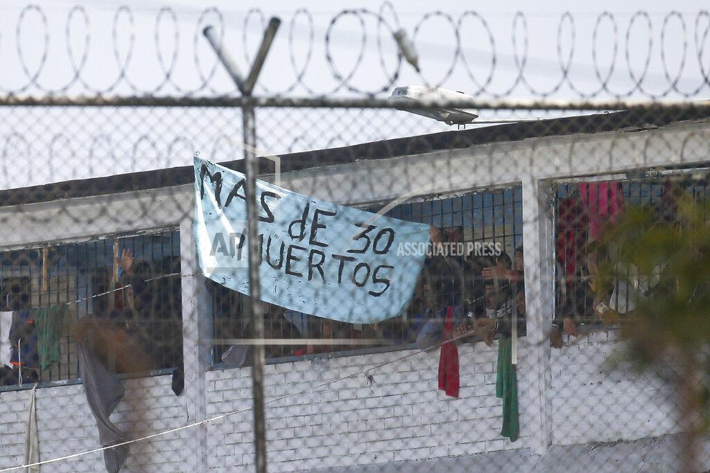 Ivan Valencia Inmates display a sign reading in Spanish "More than 30 dead" at La Modelo jail in Bogota, Colombia, Sunday, March 22, 2020. Violence broke out in the prison out of inmates' fears that authorities are not doing enough to prevent coronavirus inside overcrowded prisons. (AP Photo/Ivan Valencia)