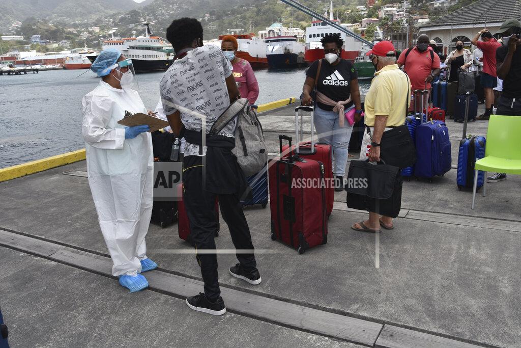 Orvil Samuel British, Canadian and U.S. nationals wait to board the Royal Caribbean cruise ship Reflection to be evacuated free of charge, in Kingstown on the eastern Caribbean island of St. Vincent, Friday, April 16, 2021. La Soufriere volcano has shot out another explosive burst of gas and ash Friday morning as the cruise ship arrived to evacuate some of the foreigners who had been stuck on a St. Vincent island by a week of violent eruptions. (AP Photo/Orvil Samuel)