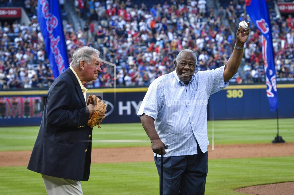 John Amis Hank Aaron holds up the ball after throwing the ceremonial last pitch to former Manager Bobby Cox after a baseball game against the Detroit Tigers and the Braves last game at Turner Field, Oct. 2, 2016, in Atlanta. (AP Photo/John Amis)