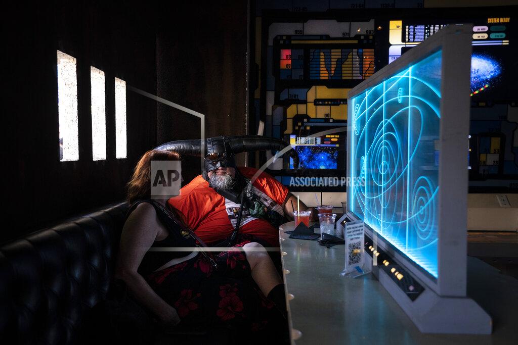 Jae C. Hong Candice Tate, left, and her boyfriend Brandon Daniels celebrate Star Wars Day at Scum and Villainy Cantina, a geek bar located on Hollywood Boulevard in Los Angeles, Tuesday, May 4, 2021. California has the lowest infection rate in the country. Los Angeles County, which is home to a quarter of the state's nearly 40 million people and has endured a disproportionate number of the state's 60,000 deaths, didn't record a single COVID-19 death Sunday or Monday, which was likely due to incomplete weekend reporting but still noteworthy. (AP Photo/Jae C. Hong)