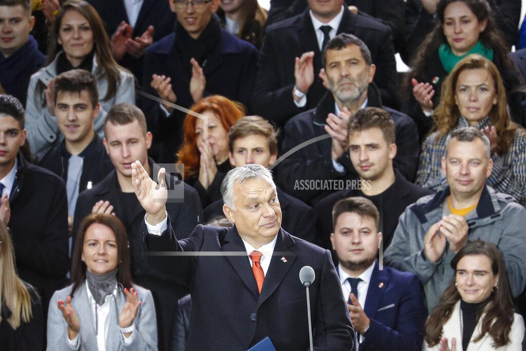 Laszlo Balogh Hungarian Prime Minister Viktor Orban waves to supporters during celebration the 65th anniversary of the 1956 Hungarian revolution, in Budapest, Hungary, Saturday, Oct. 23, 2021. Thousands of supporters of Prime Minister Viktor Orban, who is expected to deliver a speech marking the 65th anniversary of the 1956 Hungarian revolution, march in Budapest, Hungary to demonstrate loyalty to his right-wing government. (AP Photo/Laszlo Balogh)