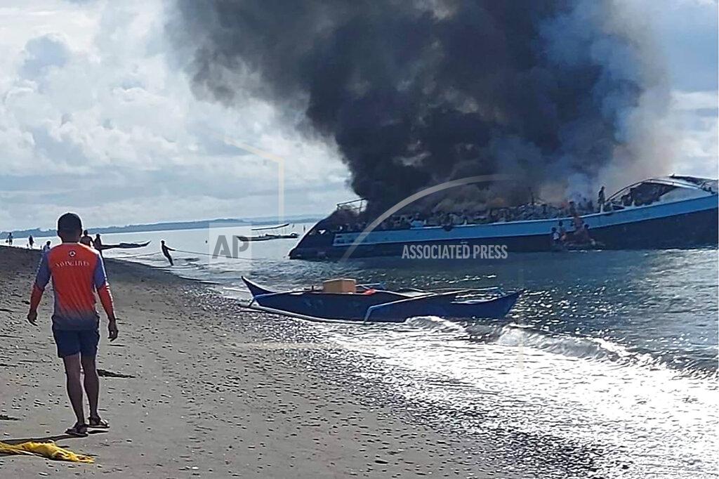 Uncredited In this handout provided by the Philippine Coast Guard, smoke billows from ferry M/V Mercraft 2 as it's towed to an island off of the town of Real, Quezon province, Philippines on Monday, May 23, 2022. The passenger ship caught fire as it neared it's port destination in Real, killing several people on board. (Philippine Coast Guard via AP Photo)