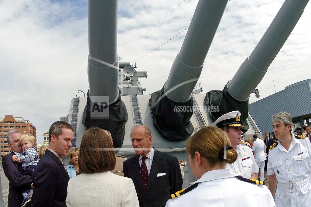 Gary C. Knapp FILE - In this file photo dated Friday, May 4, 2007, Prince Philip of England, center, greets the families of local British military personnel that are attached to the Supreme Allied Command - NATO, located in Norfolk, Va, USA, during a tour of the decommissioned battleship, the U.S.S. Wisconsin. The battleship is berthed alongside Nauticus, a maritime themed museum in Norfolk, Va. Prince Philip who died Friday April 9, 2021, aged 99, lived through a tumultuous century of war and upheavals, but he helped forge a period of stability for the British monarchy under his wife, Queen Elizabeth II. Philip helped create the Commonwealth of nations, with the queen at its head, in an attempt to bind Britain and its former colonies together on a more equal footing.(AP Photo/Gary C. Knapp, FILE)