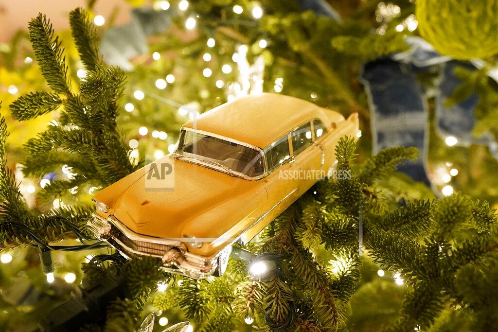 Patrick Semansky A toy car hangs in a Christmas tree in the East Room of the White House during the 2020 Christmas preview, Monday, Nov. 30, 2020, in Washington. (AP Photo/Patrick Semansky)