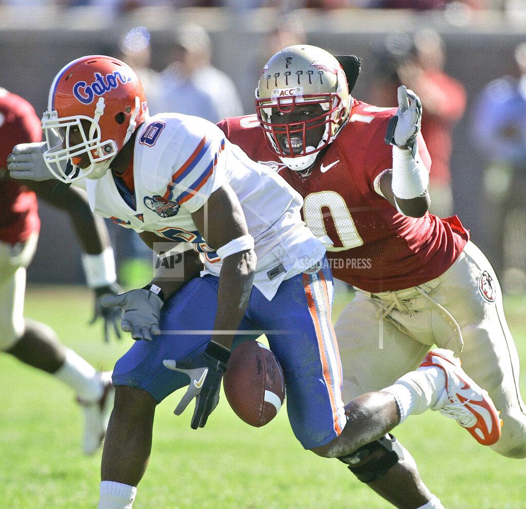 Phil Coale FILE - Florida receiver Percy Harvin, left, drops a second-quarter pass and he is hit by Florida State's Geno Hayes, right, during an NCAA college football game in Tallahasse, Fla., in this Saturday, Nov. 25, 2006, file photo. Hayes, a former NFL linebacker who starred at Florida State, has died. He was 33. The Tampa Bay Buccaneers on Tuesday, April 27, 2021, confirmed his death. He had liver disease and had been in hospice care. (AP Photo/Phil Coale, File)