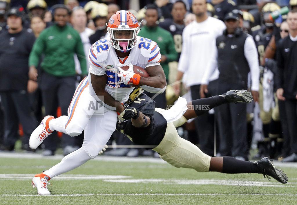 Mark Humphrey Florida running back Lamical Perine (22) gets past Vanderbilt defensive back Max Worship (14) in the first half of an NCAA college football game Saturday, Oct. 13, 2018, in Nashville, Tenn. (AP Photo/Mark Humphrey)