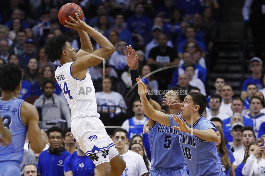 John Minchillo Seton Hall's Jared Rhoden (14) shoots against Villanova's Cole Swider (10) and Justin Moore (5) during the first half of an NCAA college basketball game, Wednesday, March 4, 2020, in Newark, N.J. (AP Photo/John Minchillo)