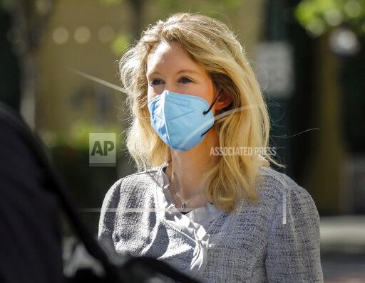 FILE - Elizabeth Holmes, founder and CEO of Theranos, left, leaves the Robert F. Peckham Federal Building in downtown San Jose, Calif., on Tuesday, May 4, 2021. The U.S. government rested its case in the trial of fallen Silicon Valley star Elizabeth Holmes on Friday, Nov 19, after spending more than two months trying to prove she bamboozled investors, patients and business partners into believing that her startup Theranos was about to reshape health care by using just a few drops for blood for tests that usually require vials of the stuff.(Nhat V. Meyer/Bay Area News Group via AP, File)