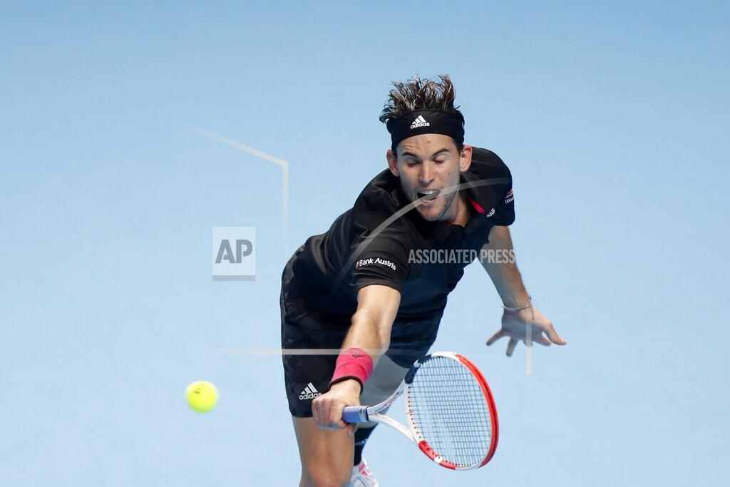 Frank Augstein Dominic Thiem of Austria returns the ball to Novak Djokovic of Serbia during their semifinal match at the ATP World Finals tennis tournament at the O2 arena in London, Saturday, Nov. 21, 2020. (AP Photo/Frank Augstein)