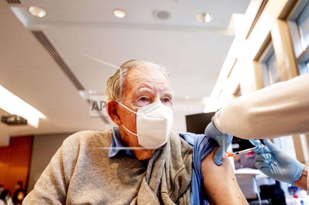 FILE - In this Jan. 12, 2021, file photo, Ken Towns receives a first dose of Pfizer-BioNTech COVID-19 vaccine from UC Davis Health in Sacramento, Calif. Uncertainty over the pace of federal COVID-19 vaccine allotments triggered anger and confusion Friday, Jan. 15, 2021, in some states where officials worried that expected shipments would not be forthcoming. (AP Photo/Noah Berger, Pool, File)