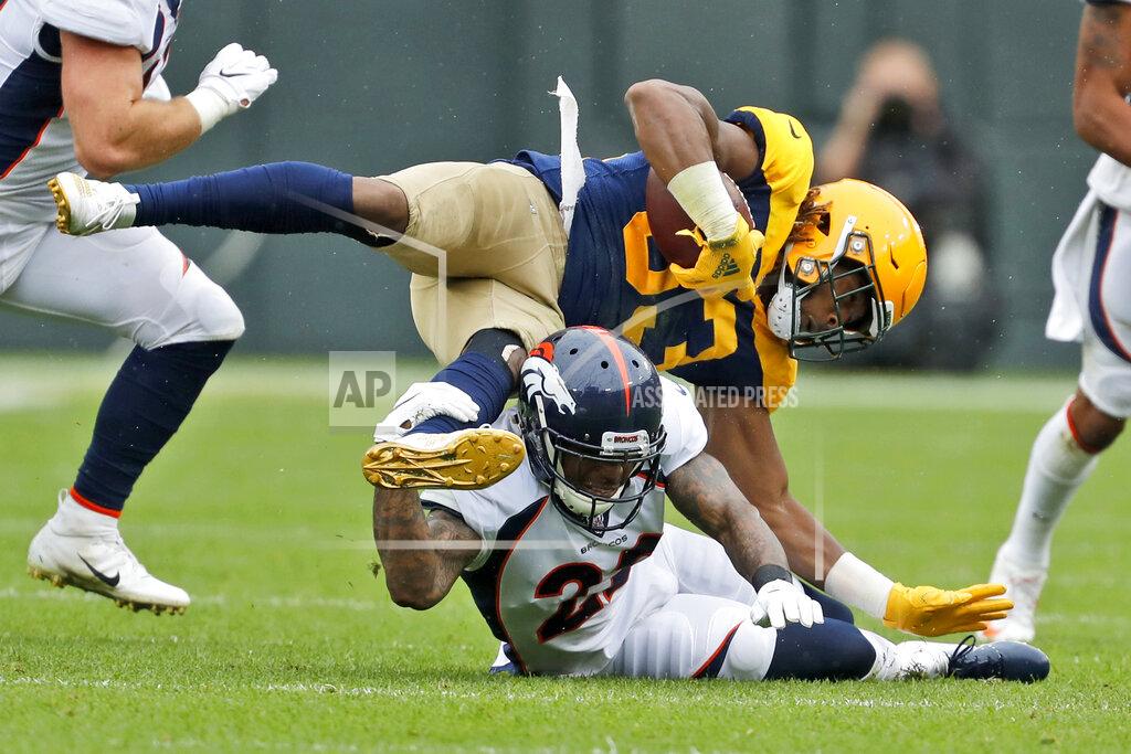Matt Ludtke Green Bay Packers running back Aaron Jones, top, falls over Denver Broncos defensive back Kareem Jackson during the first half of an NFL football game Sunday, Sept. 22, 2019, in Green Bay, Wis. (AP Photo/Matt Ludtke)