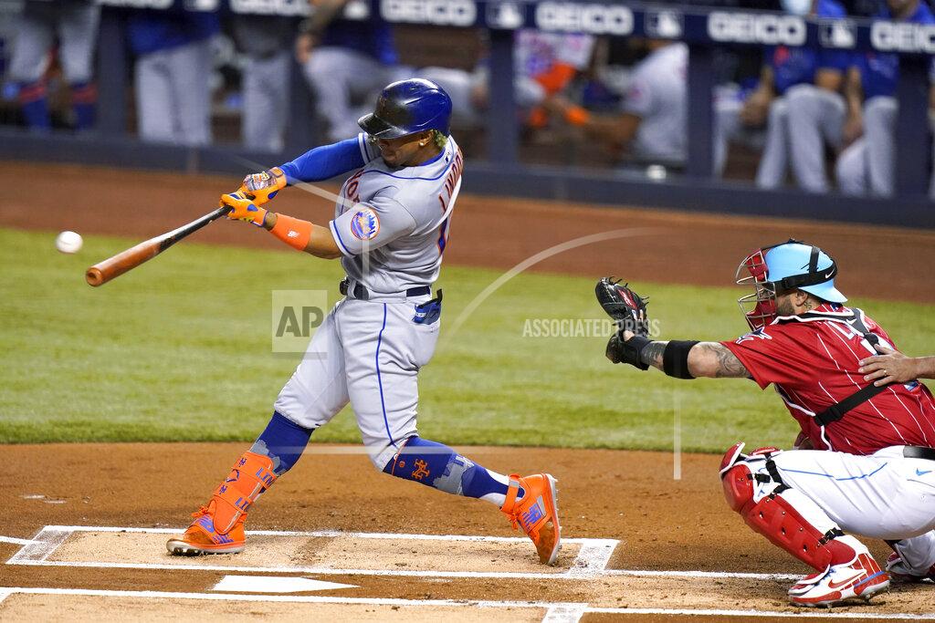 Lynne Sladky New York Mets' Francisco Lindor hits a double next to Miami Marlins catcher Sandy Leon durning the first inning of a baseball game Friday, May 21, 2021, in Miami. (AP Photo/Lynne Sladky)