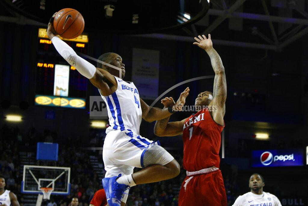 Buffalo guard Davonta Jordan (4) drives against Miami of Ohio guard Nike Sibande (1) during the first half of an NCAA college Basketball game, Saturday, Jan. 12, 2019, in Buffalo N.Y. (AP Photo/Jeffrey T. Barnes)