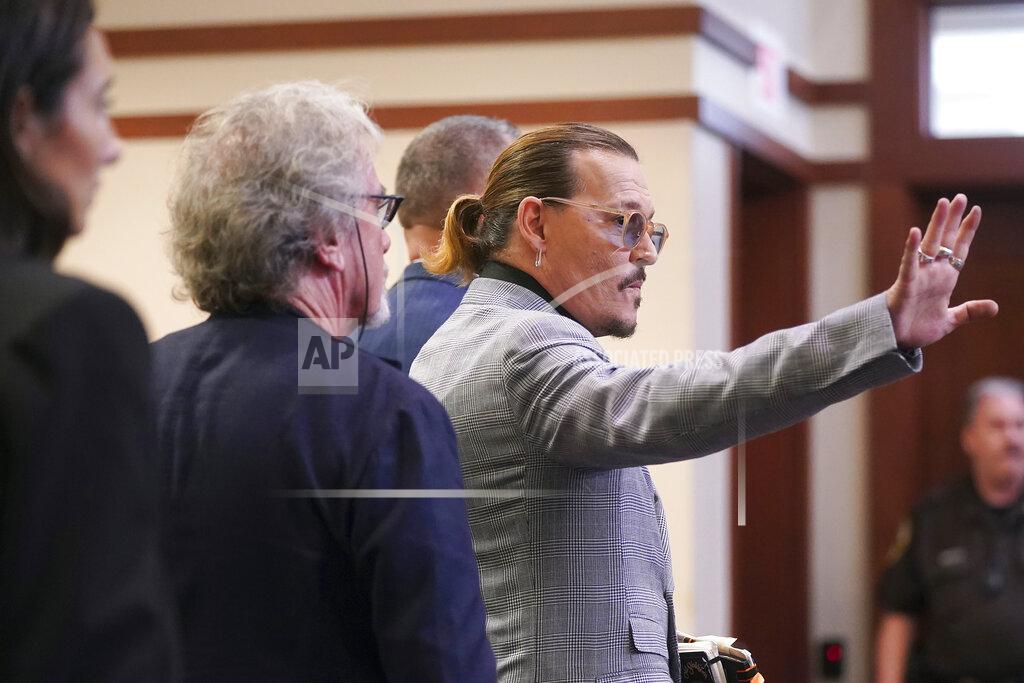 Shaw Thew Actor Johnny Depp waves as he leaves the courtroom at the Fairfax County Circuit Courthouse in Fairfax, Va., Thursday, May 19, 2022. Actor Johnny Depp sued his ex-wife Amber Heard for libel in Fairfax County Circuit Court after she wrote an op-ed piece in The Washington Post in 2018 referring to herself as a "public figure representing domestic abuse." (Shawn Thew/Pool Photo via AP)