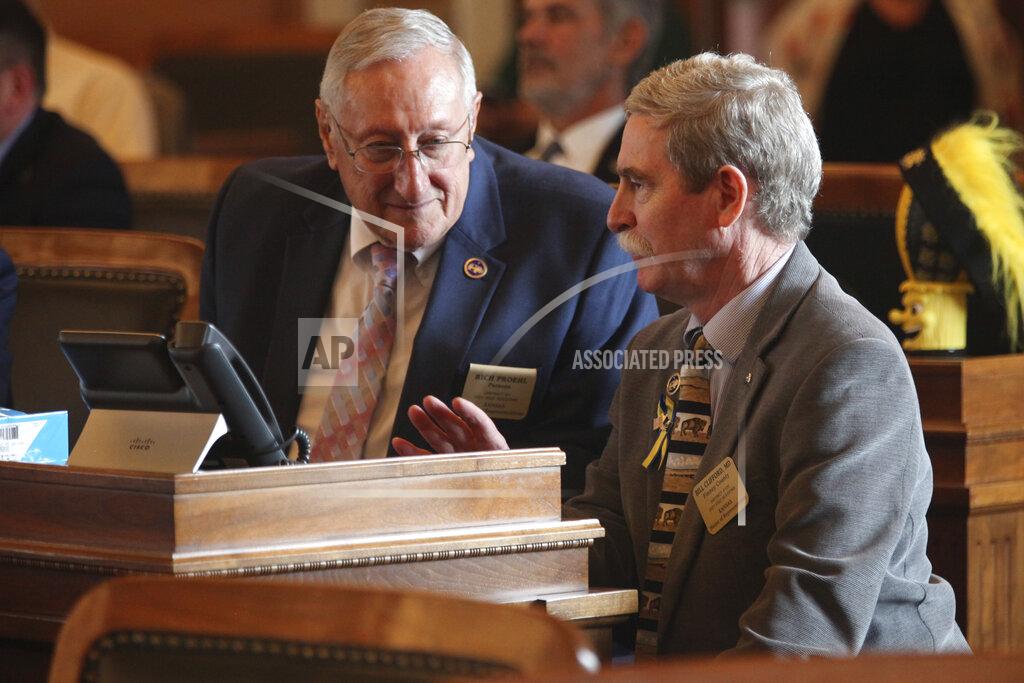 John Hanna Kansas state Reps. Rich Proehl, left, R-Parsons, and Bill Clifford, right, R-Garden City, confer during a House discussion of legislation providing $50 million in relief to businesses, Monday, May 23, 2022, at the Statehouse in Topeka, Kan. The relief would go to businesses forced to shut down or curb their operations in 2020 and 2021 because of COVID-19 restrictions. (AP Photo/John Hanna)