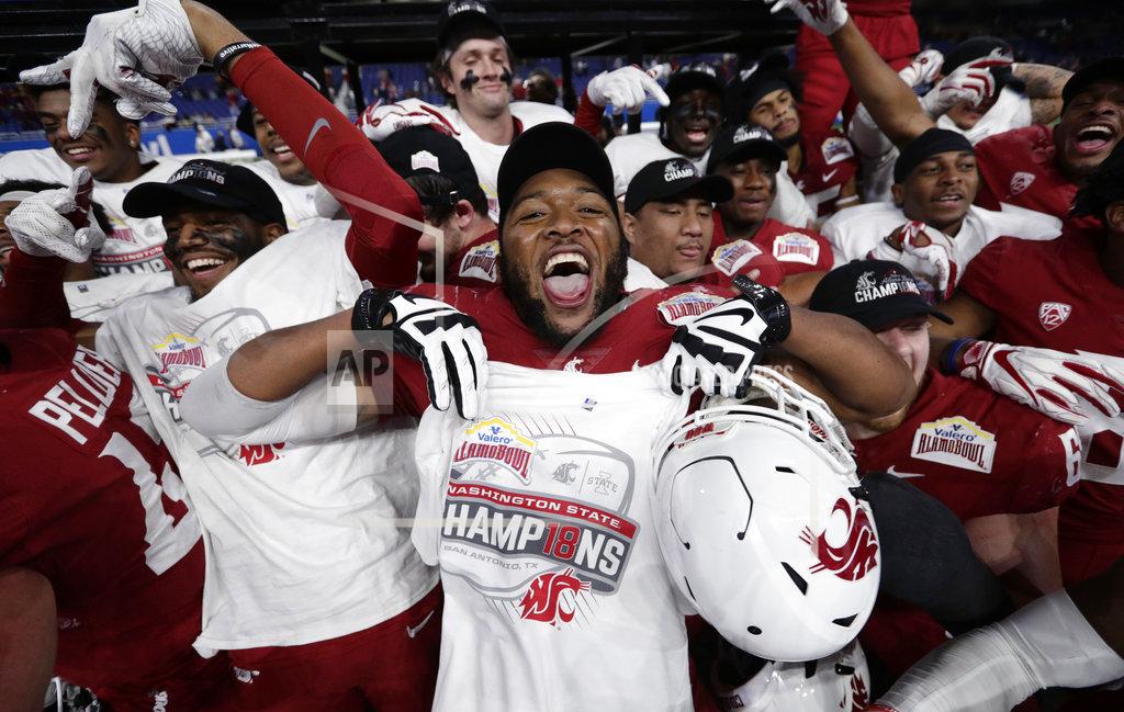Eric Gay Washington State players celebrate a 28-26 win over Iowa State in the Alamo Bowl NCAA college football game, Friday, Dec. 28, 2018, in San Antonio. (AP Photo/Eric Gay)