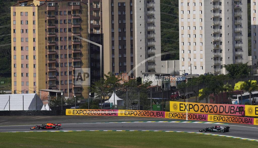 Andre Penner Red Bull's Max Verstappen, left, steers his car followed by Mercedes' Lewis Hamilton, during the Brazilian Formula One Grand Prix at the Interlagos race track in Sao Paulo, Brazil, Sunday, Nov. 14, 2021. (AP Photo/Andre Penner)