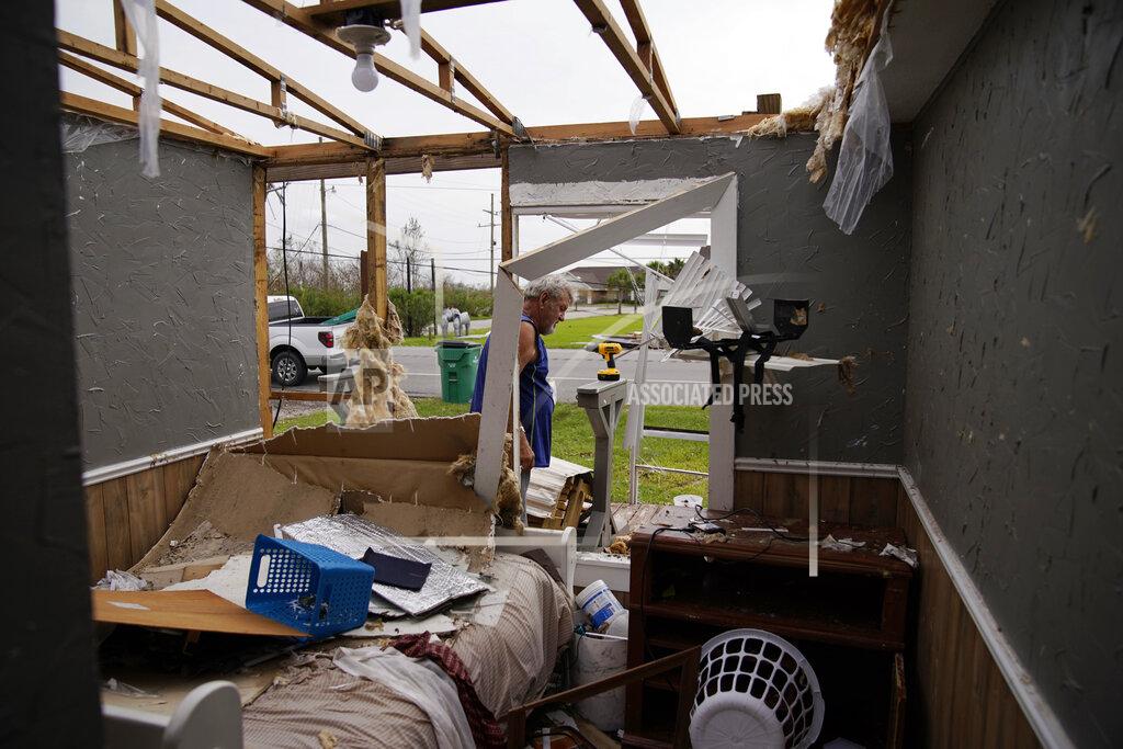 John Locher Philip Adams salvages metal and wood at his hurricane destroyed home in the aftermath of Hurricane Ida, Monday, Sept. 6, 2021, in Lockport, La. (AP Photo/John Locher)