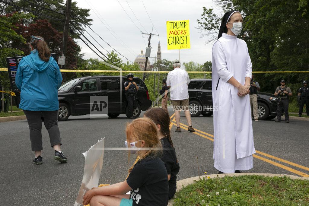 Jacquelyn Martin Sister Quincy Howard, right, a Dominican nun, arrives to protest the arrival of President Donald Trump to the Saint John Paul II National Shrine, Tuesday, June 2, 2020, in Washington. Many demonstrators said they were dismayed when Trump staged a visit to the historic St. John’s Church across from the White House and held up a Bible after authorities had cleared the area of peaceful protesters. (AP Photo/Jacquelyn Martin)