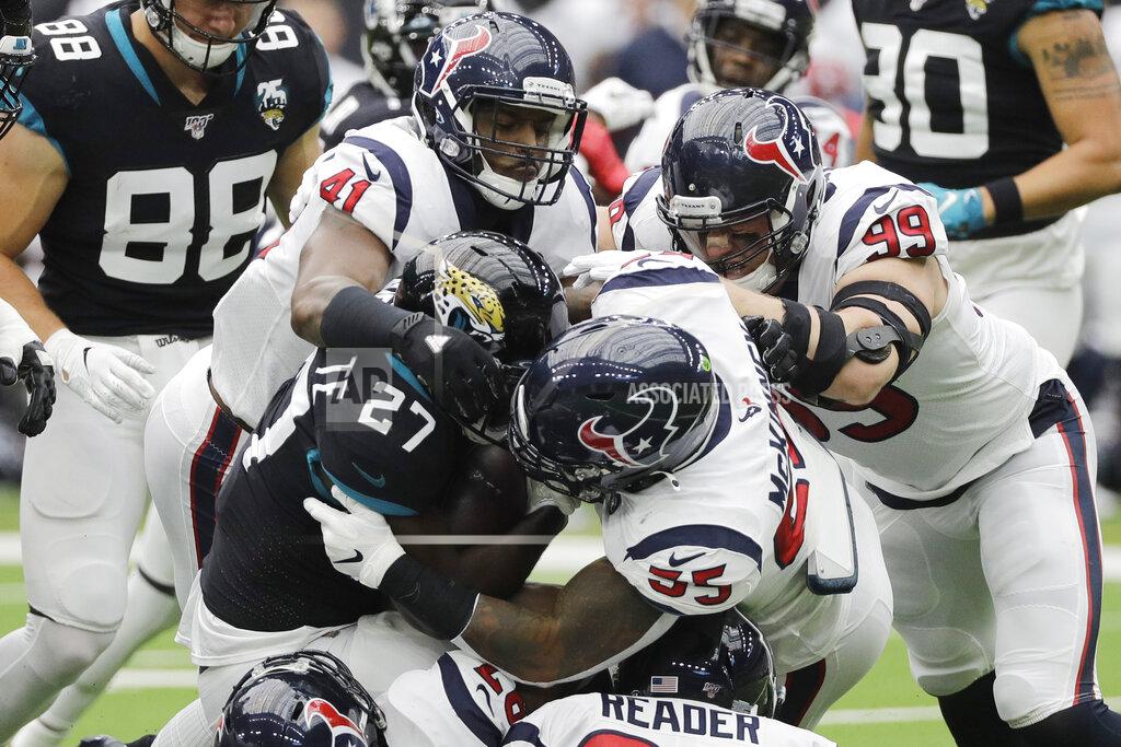 David J. Phillip Jacksonville Jaguars running back Leonard Fournette (27) is stopped by Houston Texans inside linebacker Benardrick McKinney (55) and inside linebacker Zach Cunningham (41) during the first half of an NFL football game Sunday, Sept. 15, 2019, in Houston. (AP Photo/David J. Phillip)