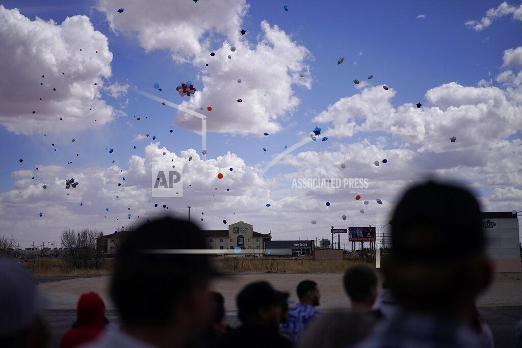 People watch after releasing balloons during a memorial for Jackson Zinn at a Texas Roadhouse restaurant, Thursday, March 17, 2022, in Hobbs, New Mexico. Zinn, who worked at the restaurant, was killed with several other student golfers and the coach of University of the Southwest in a crash in Texas. (AP Photo/John Locher)