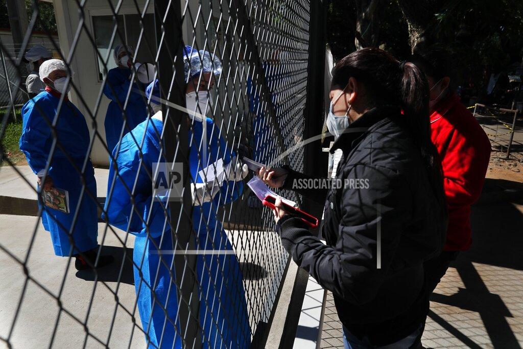 Jorge Saenz The relative of a COVID-19 patient hospitalized at Ineram Hospital's ICU, is given a list of prescription medication to buy from a doctor through the hospital fence in Asuncion, Paraguay, Monday, May 24, 2021. (AP Photo/Jorge Saenz)