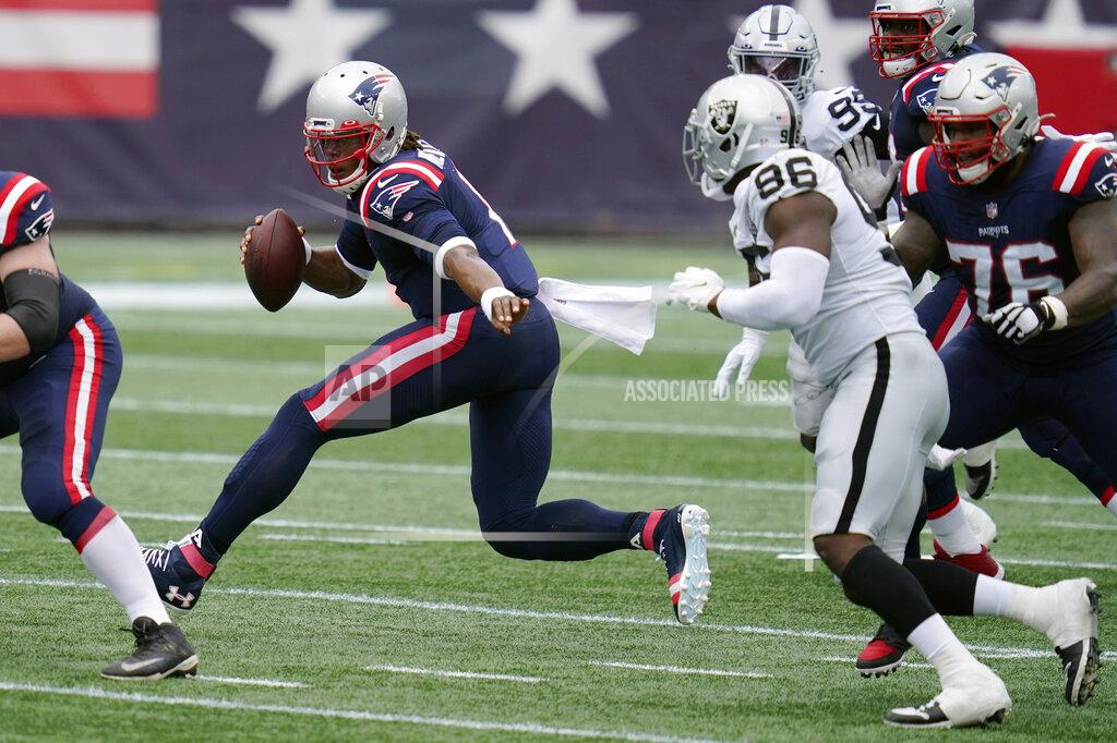 Charles Krupa New England Patriots quarterback Cam Newton scrambles away from Las Vegas Raiders defensive end Clelin Ferrell (96) in the first half of an NFL football game, Sunday, Sept. 27, 2020, in Foxborough, Mass. (AP Photo/Charles Krupa)