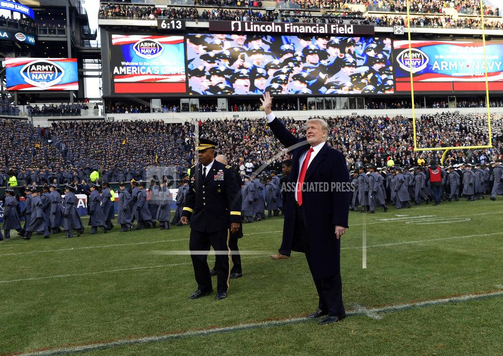 Susan Walsh President Donald Trump waves to the crowd as the walks off of the field before the start of the Army-Navy NCAA college football game in Philadelphia, Saturday, Dec. 8, 2018. (AP Photo/Susan Walsh)