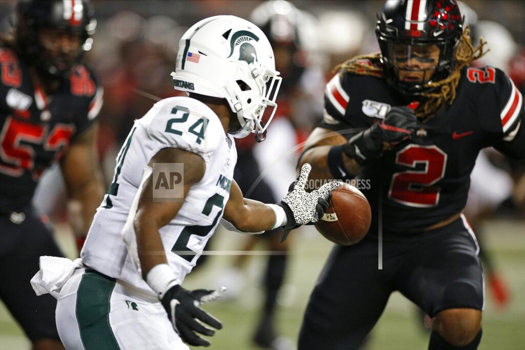 Jay Laprete Michigan State running back Elijah Collins, left, fumbles the ball in front of Ohio State defensive end Chase Young during the first half of an NCAA college football game Saturday, Oct. 5, 2019, in Columbus, Ohio. (AP Photo/Jay LaPrete)