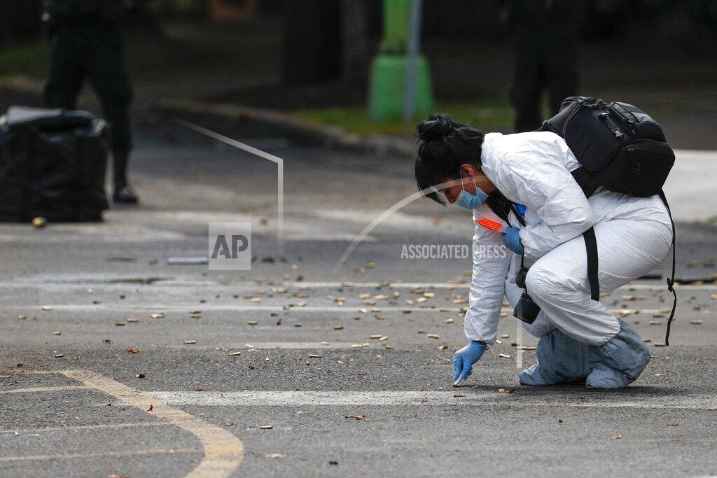 Rebecca Blackwell A forensic investigator collects cartridges at the scene where the Mexican capital's police chief was attacked by gunmen in Mexico City, Friday, June 26, 2020. Heavily armed gunmen attacked and wounded Omar García Harfuch in an operation that left several dead. (AP Photo/Rebecca Blackwell)