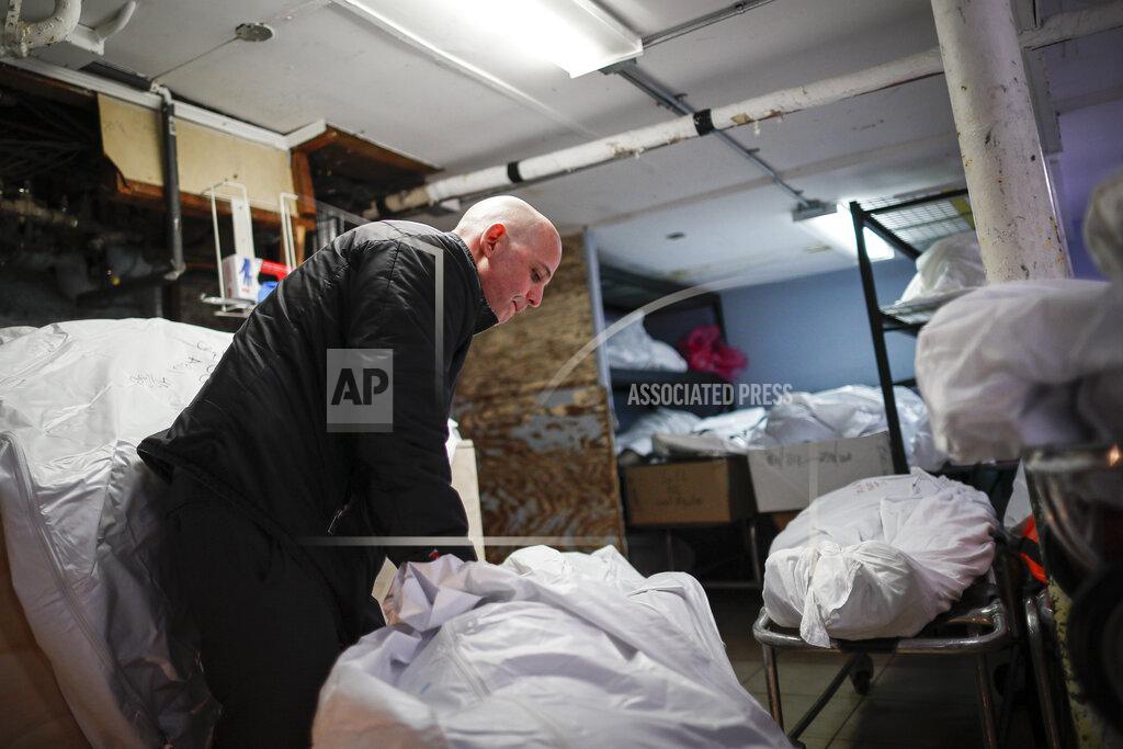 John Minchillo FILE - In this April 2, 2020, file photo, Pat Marmo, owner of Daniel J. Schaefer Funeral Home, walks through his body holding facility in the Brooklyn borough of New York. The U.S. death toll from COVID-19 has topped 500,000 — a number so staggering that a top health researchers says it is hard to imagine an American who hasn't lost a relative or doesn't know someone who died. (AP Photo/John Minchillo, File)