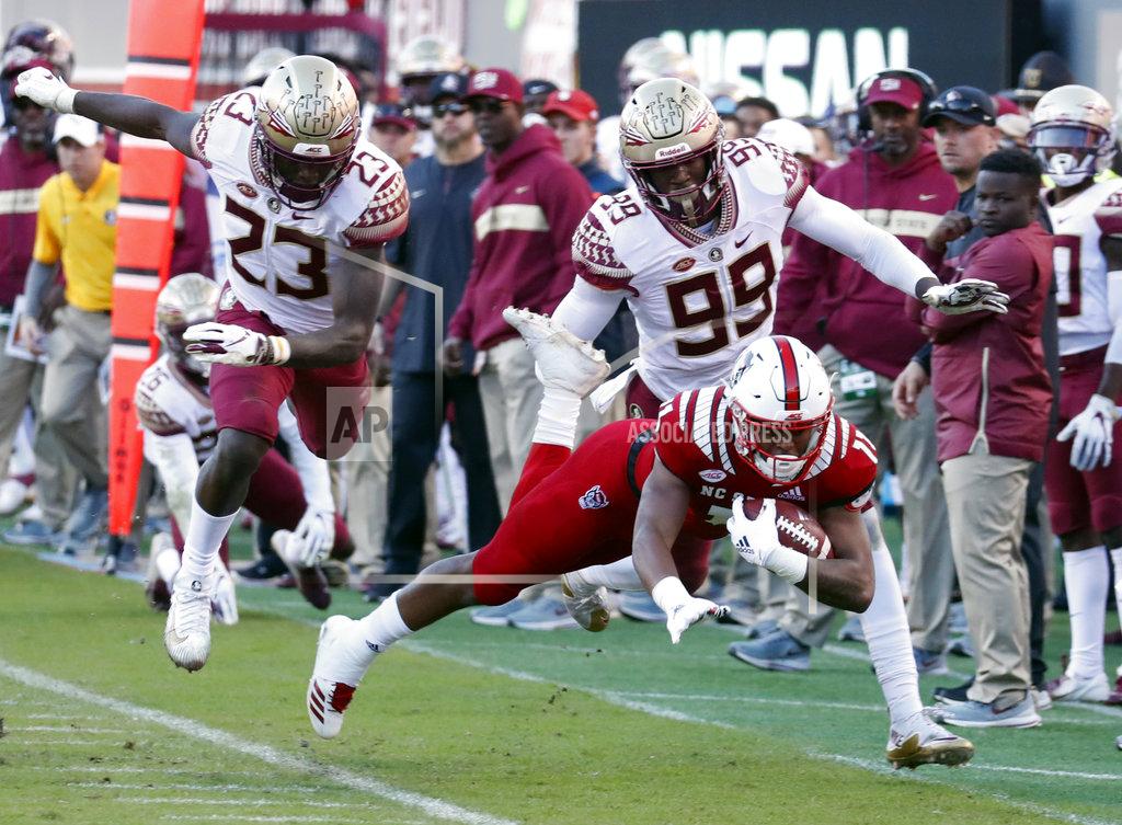 Chris Seward North Carolina State's Jakobi Meyers (11) is run out of bounds by Florida State's Hamsah Nasirildeen (23) and Brian Burns (99) after making a catch during the first half of an NCAA college football game in Raleigh, N.C., Saturday, Nov. 3, 2018. (AP Photo/Chris Seward)