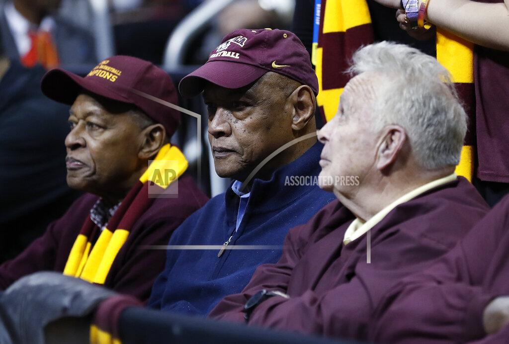 David Goldman FILE - In this March 22, 2018, file photo, Loyola Chicago team members from 1963, Jerry Harkness, Les Hunter and John Egan, from left, watch the second half of a regional semifinal NCAA college basketball tournament game between Loyola and Nevada in Atlanta. Hunter, a star on Loyola Chicago's barrier-breaking 1963 NCAA championship team, died Friday, March 27, 2020, the school said. He was 77 and had been battling cancer. (AP Photo/David Goldman, File)