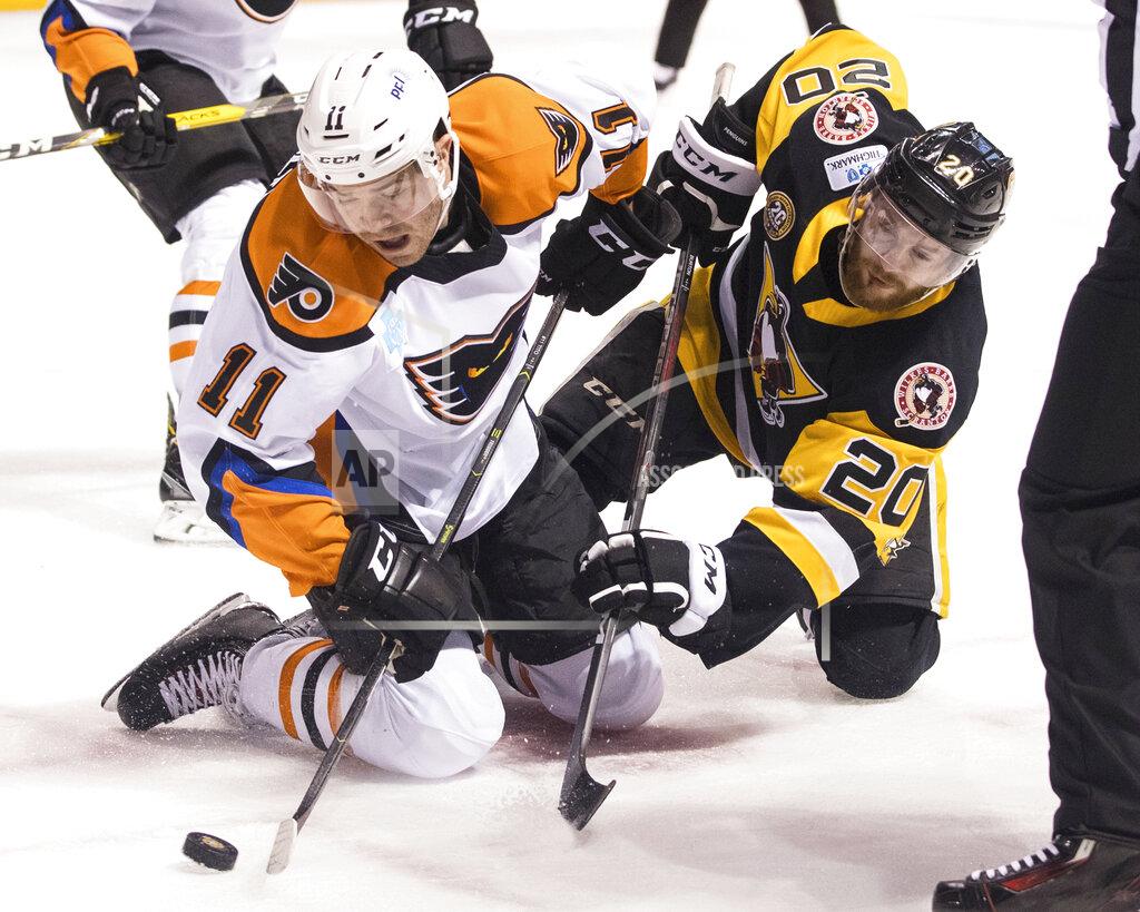 Christopher Dolan FILE - In this March 16, 2019, file photo, Lehigh Valley Phantoms' Steven Swavely (11) moves the puck past the Wilkes-Barre/Scranton Penguins' Jarrett Burton after a faceoff during an AHL hockey game at Mohegan Sun Arena in Wilkes-Barre, Pa. The American Hockey League has canceled the rest of its season because of the coronavirus pandemic. President and CEO David Andrews announced the league ‘has determined that the resumption and completion of the 2019-20 season is not feasible in light of current conditions.’ The AHL's Board of Governors made that determination in a conference call Friday, May 8, 2020. (Christopher Dolan/The Citizens' Voice via AP, File)