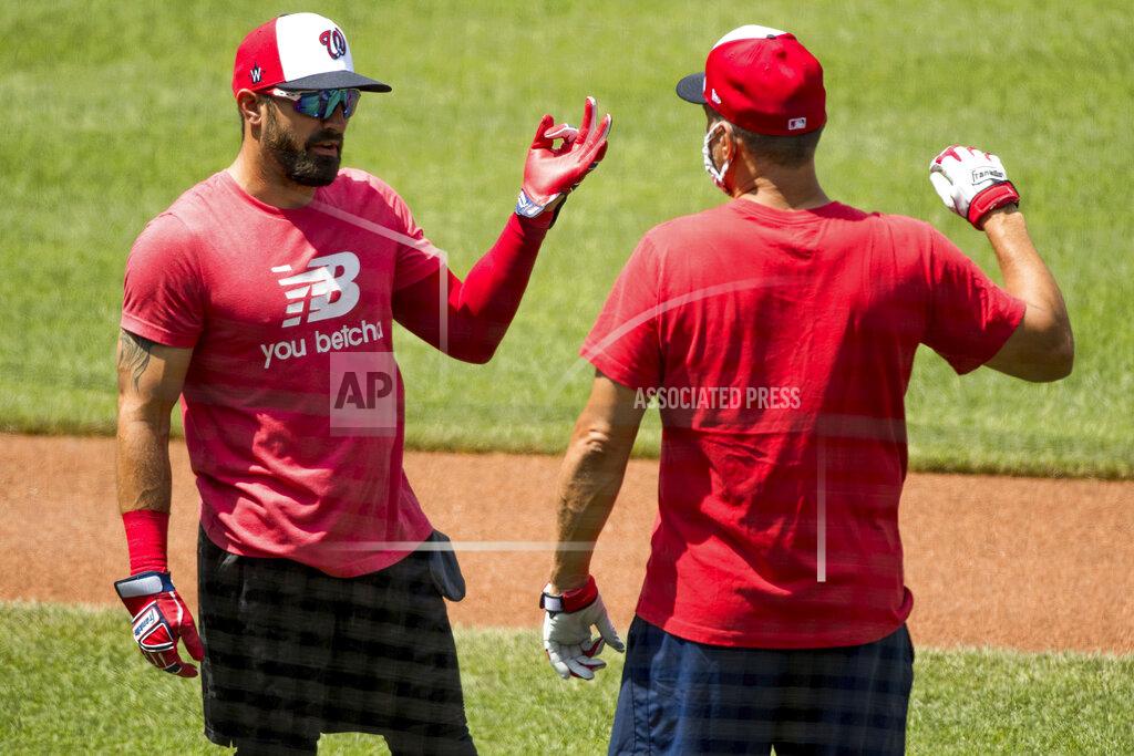 Andrew Harnik Washington Nationals' Adam Eaton (2), left, speaks with a staff member as the Washington Nationals hold their first training camp work out at Nationals Stadium, Friday, July 3, 2020, in Washington. (AP Photo/Andrew Harnik)