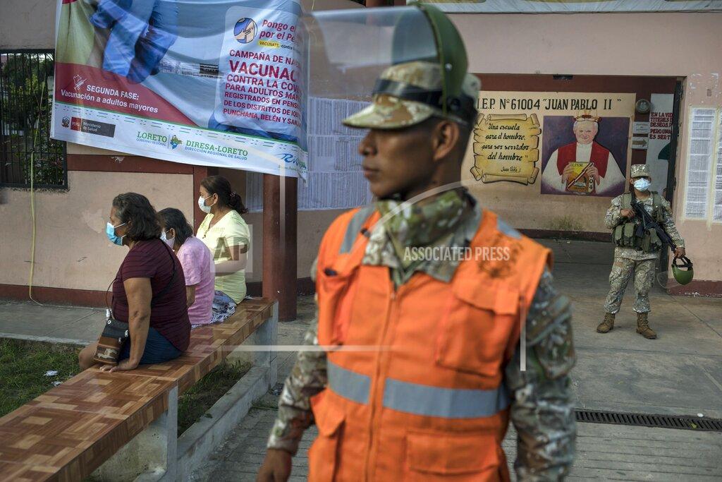 Rodrigo Abd Soldiers stand guard during a vaccination campaign for the elderly in Iquitos, Peru, Thursday, March 18, 2021. Despite a scandal that shook the government in Peru's capital when over 480 government officials took advantage of their privileged positions to secretly receive early inoculations ahead of healthcare workers battling the new coronavirus pandemic, 66 people with connections in Iquitos jumped the queue this week to be vaccinated against COVID-19. (AP Photo/Rodrigo Abd)