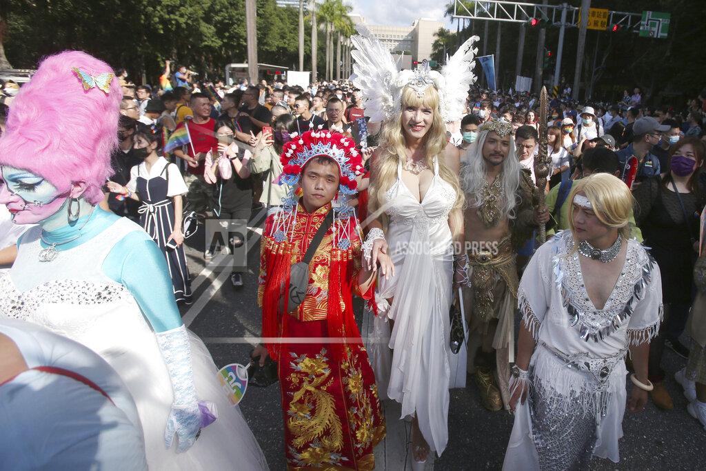 Chiang Ying-Ying Participants march through a street during a pride parade in Taipei, Taiwan, Saturday, Oct. 31, 2020. (AP Photo/Chiang Ying-ying)
